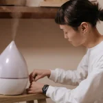 A woman using a humidifier at home