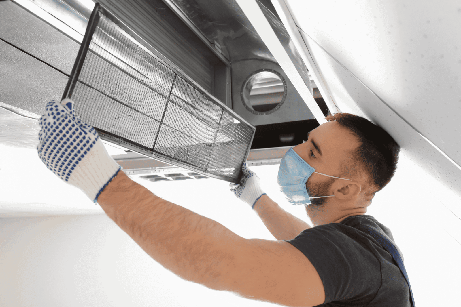 an HVAC technician checks the air filter in a vented system