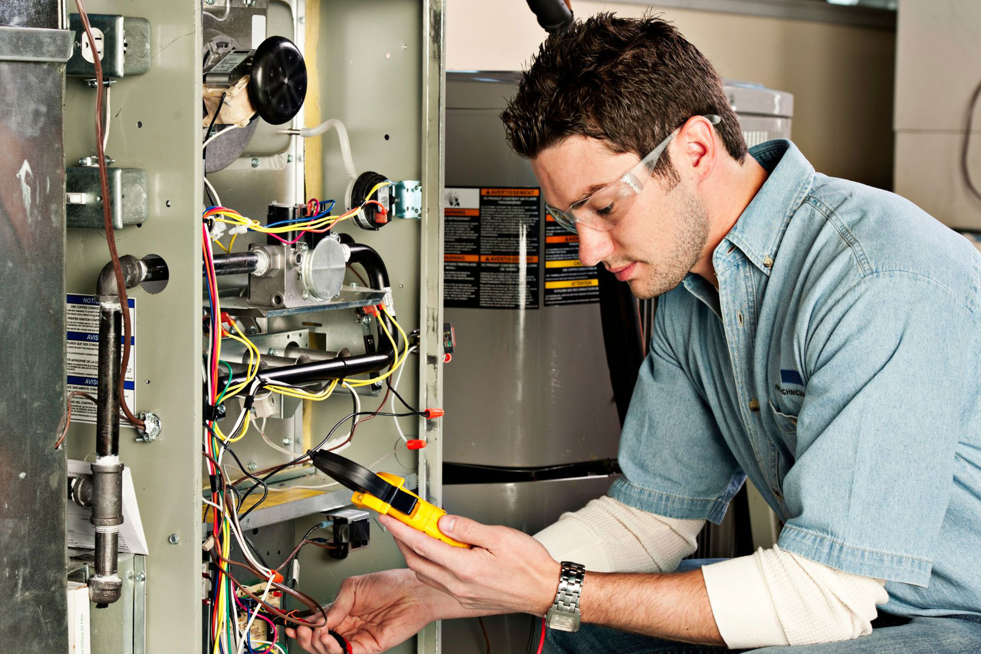 An HVAC technician testing the furnace