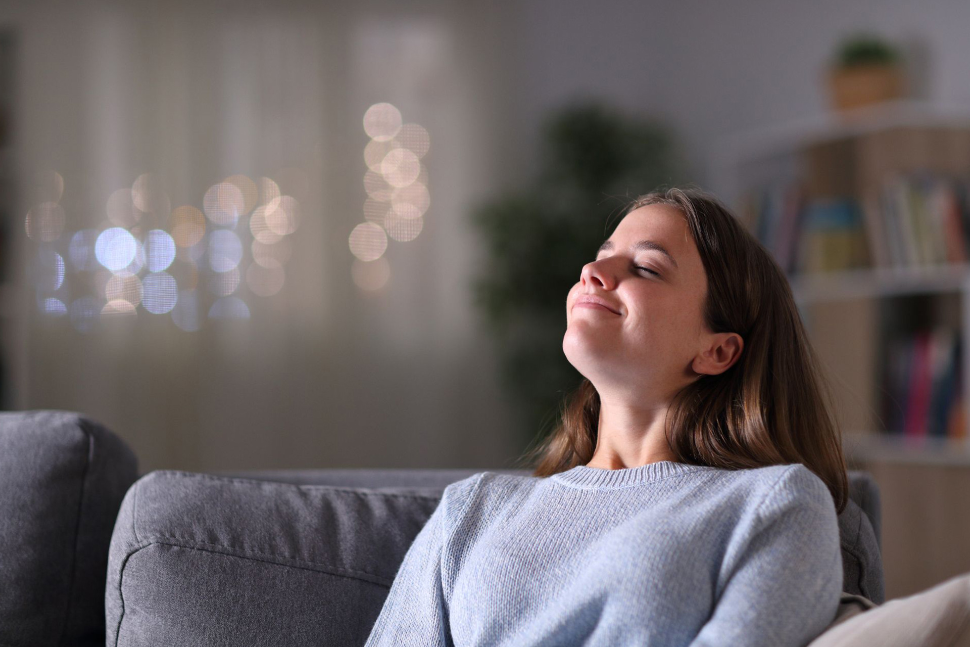 A woman breathing in her home’s fresh indoor air