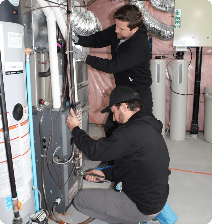 Technician fixing a furnace issue in a Kitchener home - LG Home Comfort