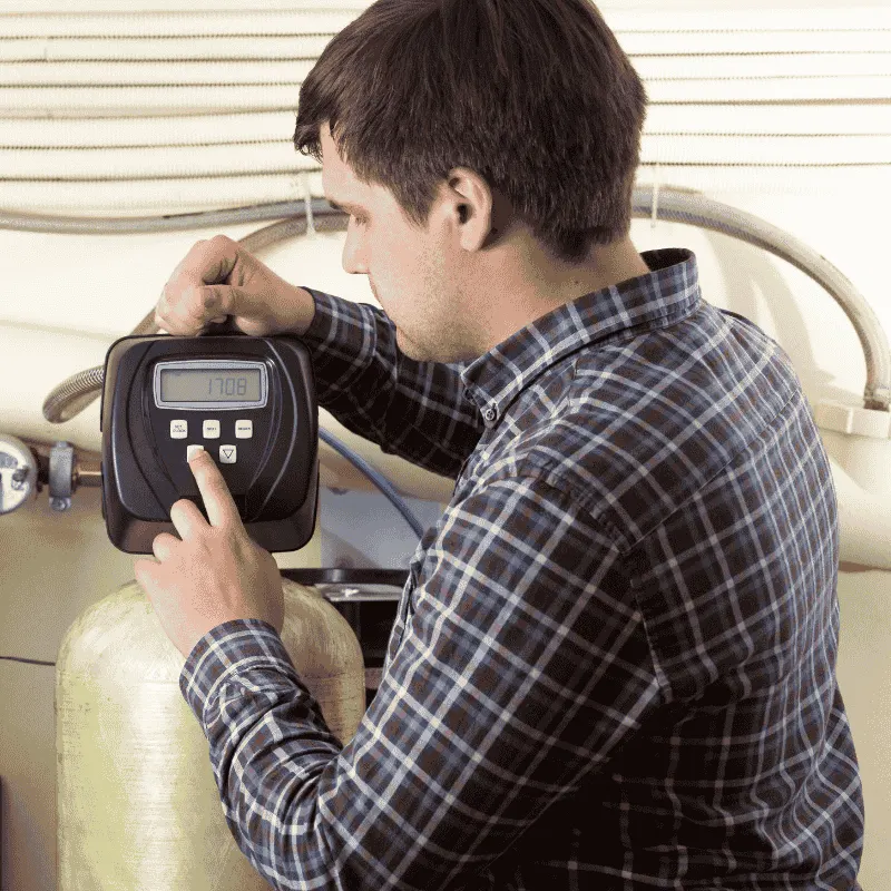 Technician from LG Home Comfort installing a water purifier in Kitchener home