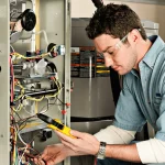 A technician testing a furnace system for a furnace burning smell