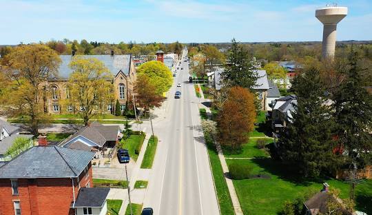 Aerial view of a small town main street with water tower.