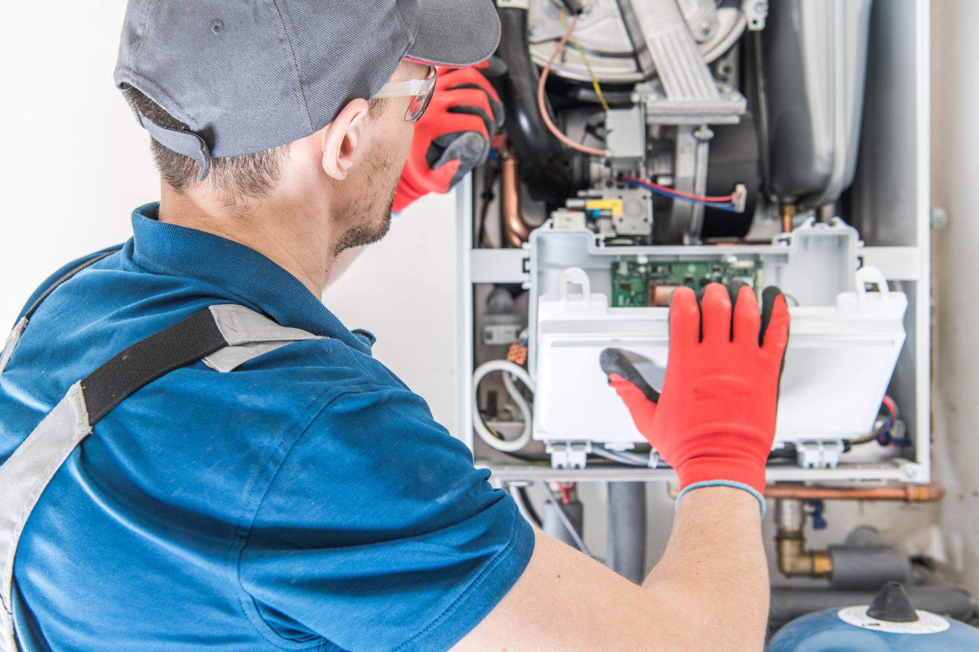 An HVAC technician inspects all parts of a furnace to determine why the furnace stopped working