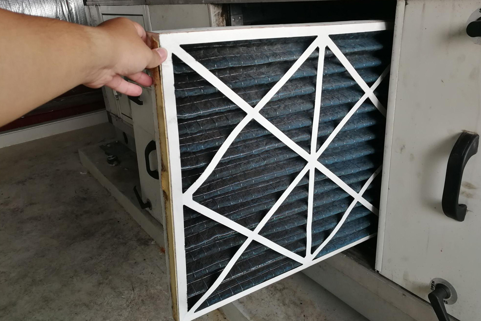 HVAC Technician replacing the air filter in a furnace