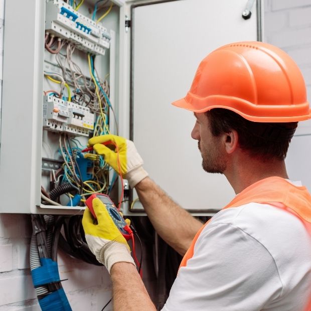 Professional electrician repairing circuit breaker in Ontario residence by LG Home Comfort