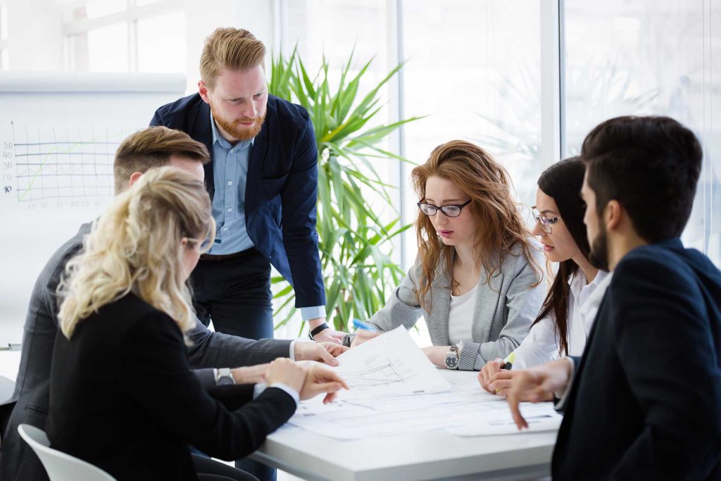 Team reviewing documents together at a meeting table.