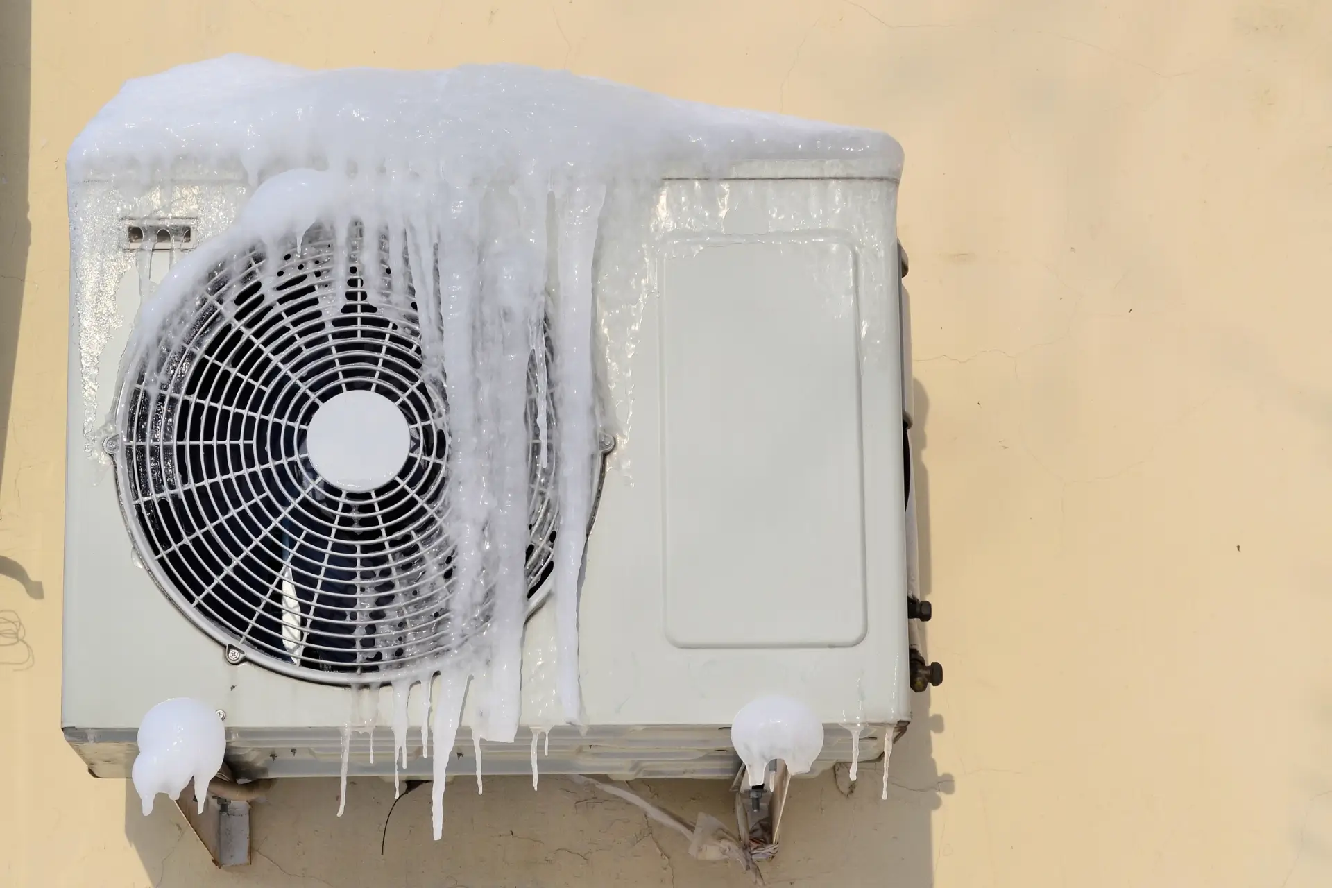 Outdoor unit covered in icicles during winter