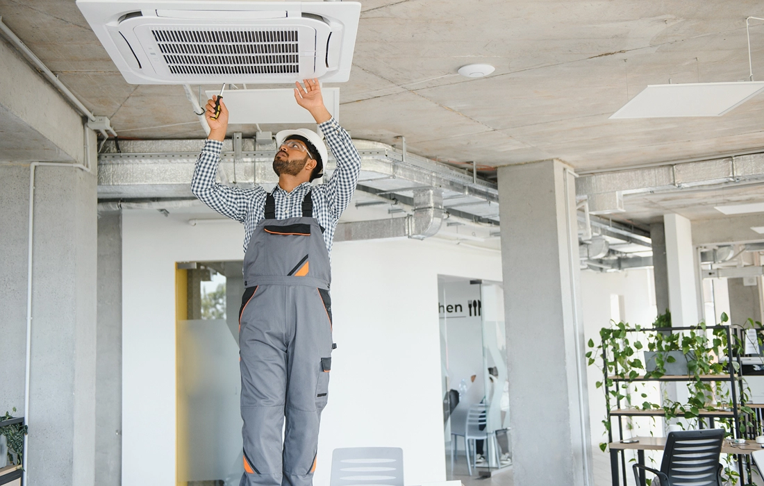 An HVAC technician setting up a new air conditioner 