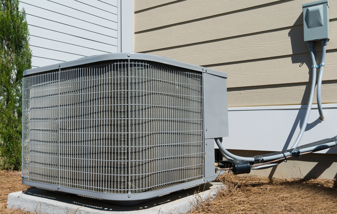 Outdoor AC unit connected to the house