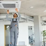 An HVAC technician setting up a new air conditioner 