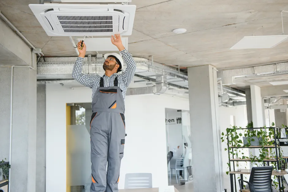 An HVAC technician setting up a new air conditioner 