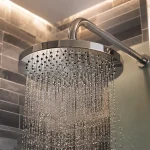 A grey stainless steel shower head 