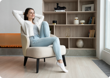 Woman relaxing in armchair at home.