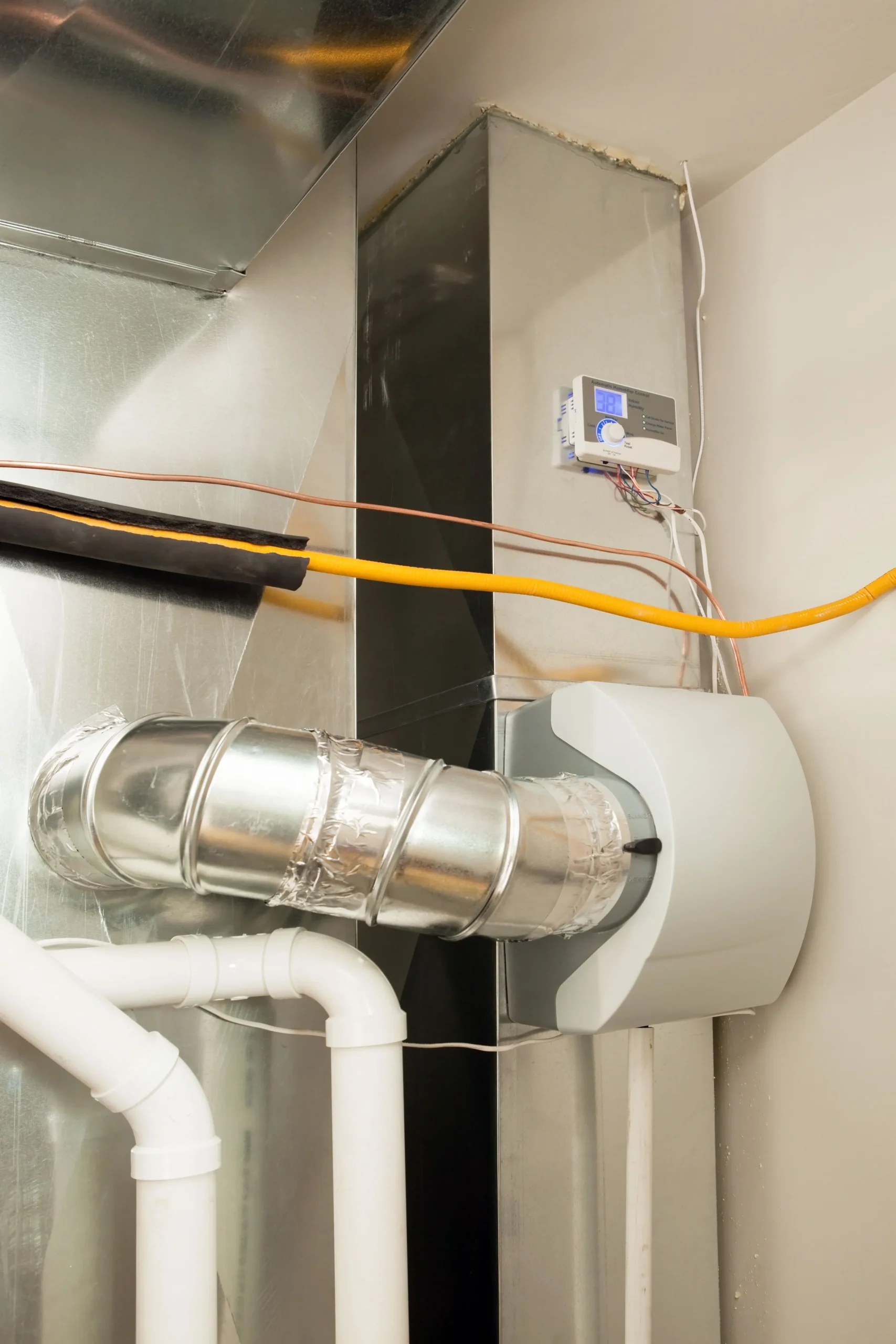 Residential whole-home bypass humidifier unit mounted on HVAC supply air ductwork with digital control panel interface.