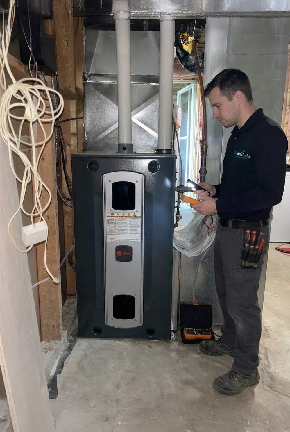 LG Home Comfort worker testing a newly installed furnace.